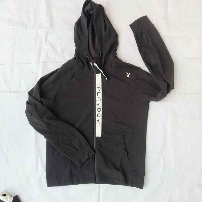 Elevate your casual wardrobe with this stylish Playboy black hoodie. Featuring a sleek design, this hoodie comes with a white zipper and the iconic Playboy logo prominently displayed on the front. The hoodie is made from high-quality, comfortable fabric, perfect for everyday wear. The adjustable drawstring hood and front pockets add functionality and style, making it a versatile addition to your collection. Whether you're lounging at home or stepping out, this Playboy hoodie ensures you do it in style.